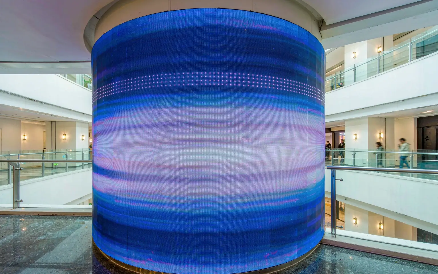 Cylindrical led display wrapped around a mall atrium column using led flexible screen modules with a seamless curved surface