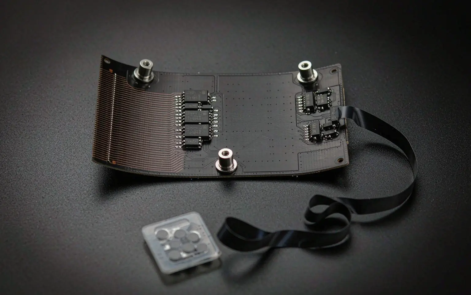 Rear side of a flexible led module showing flexible circuit board, driver chips and magnetic mounting studs